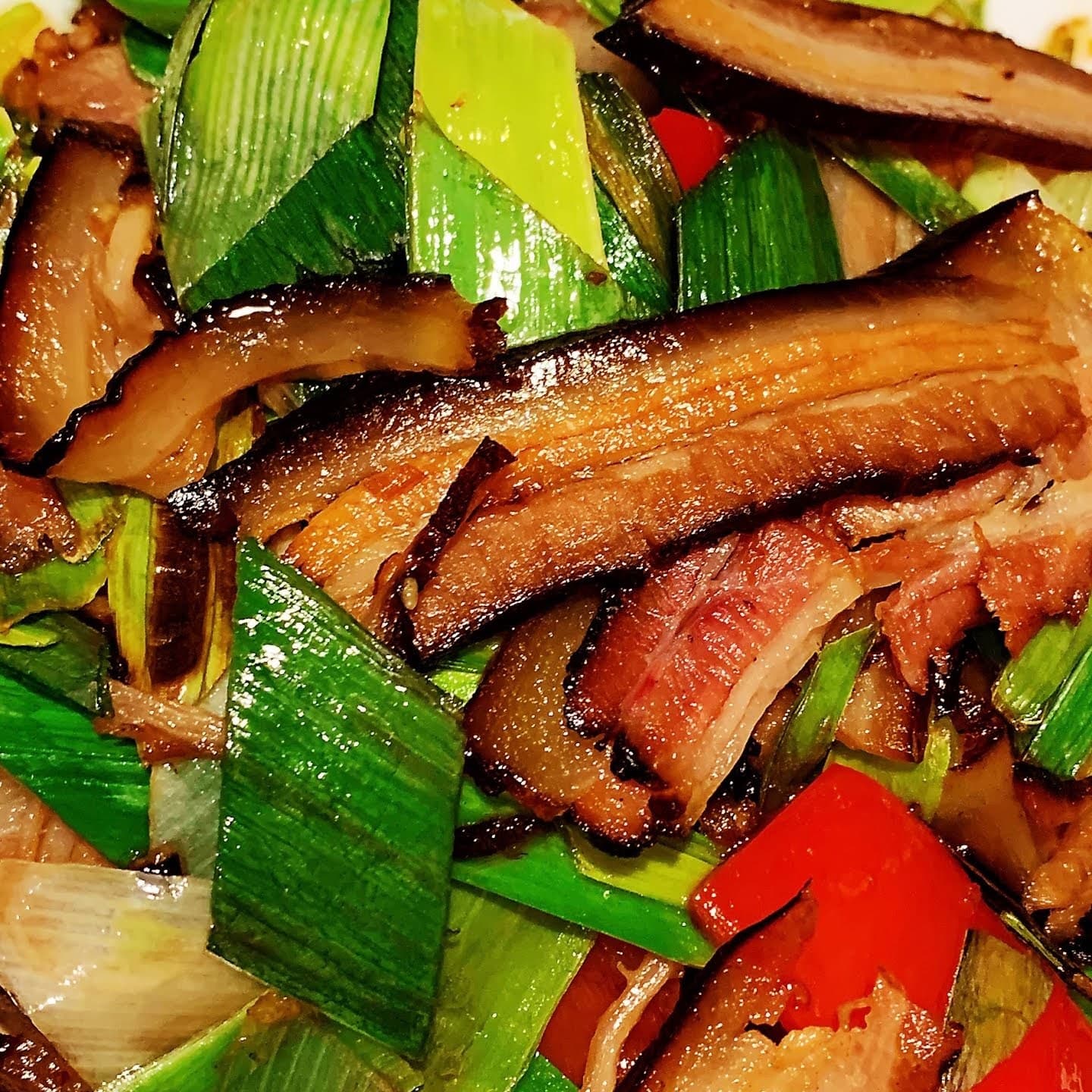 Rich braised Sichuan dish with sesame and fresh scallions